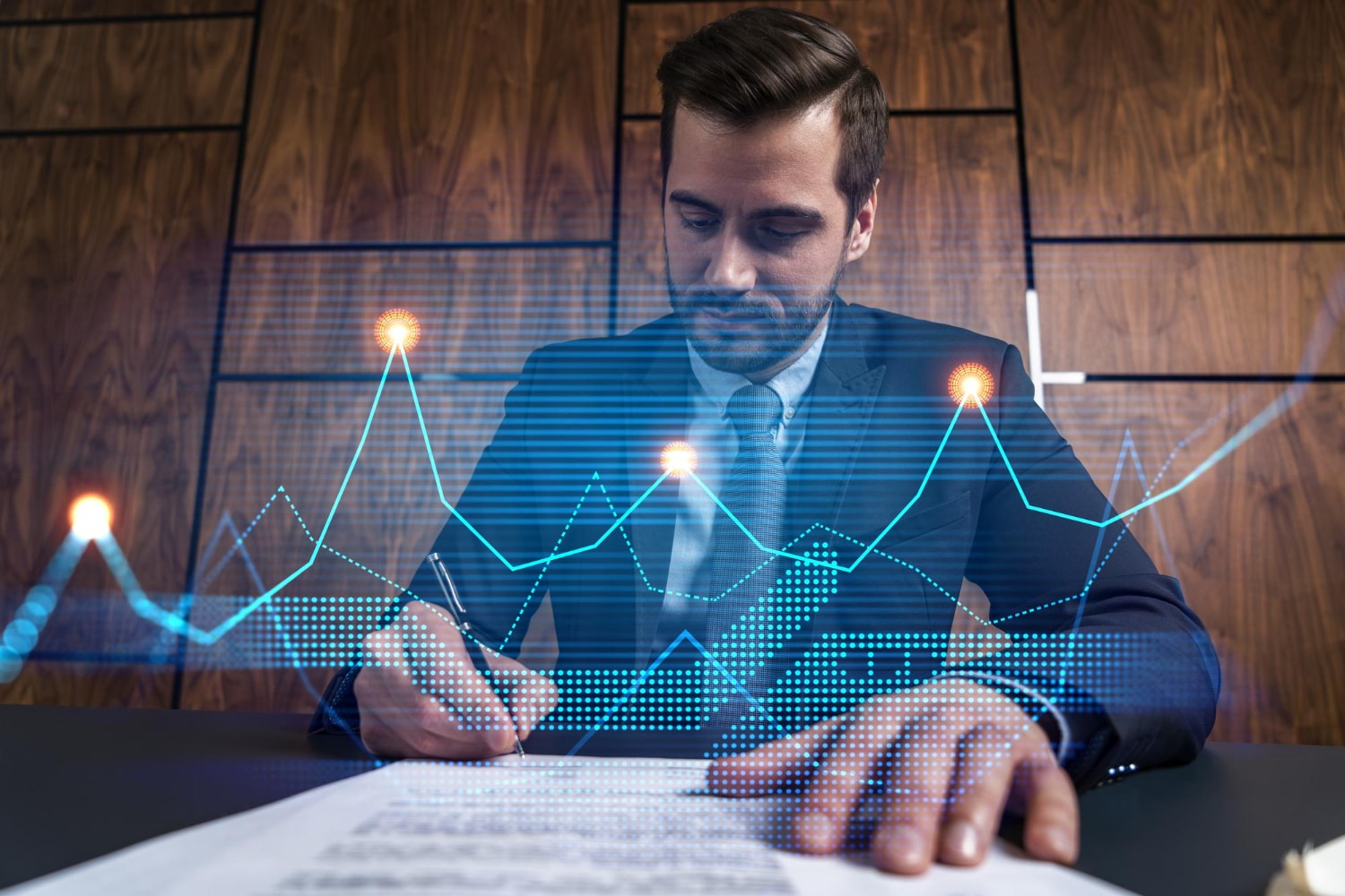 Businessman Concentrating On Document With Glowing Financial Charts Overlay