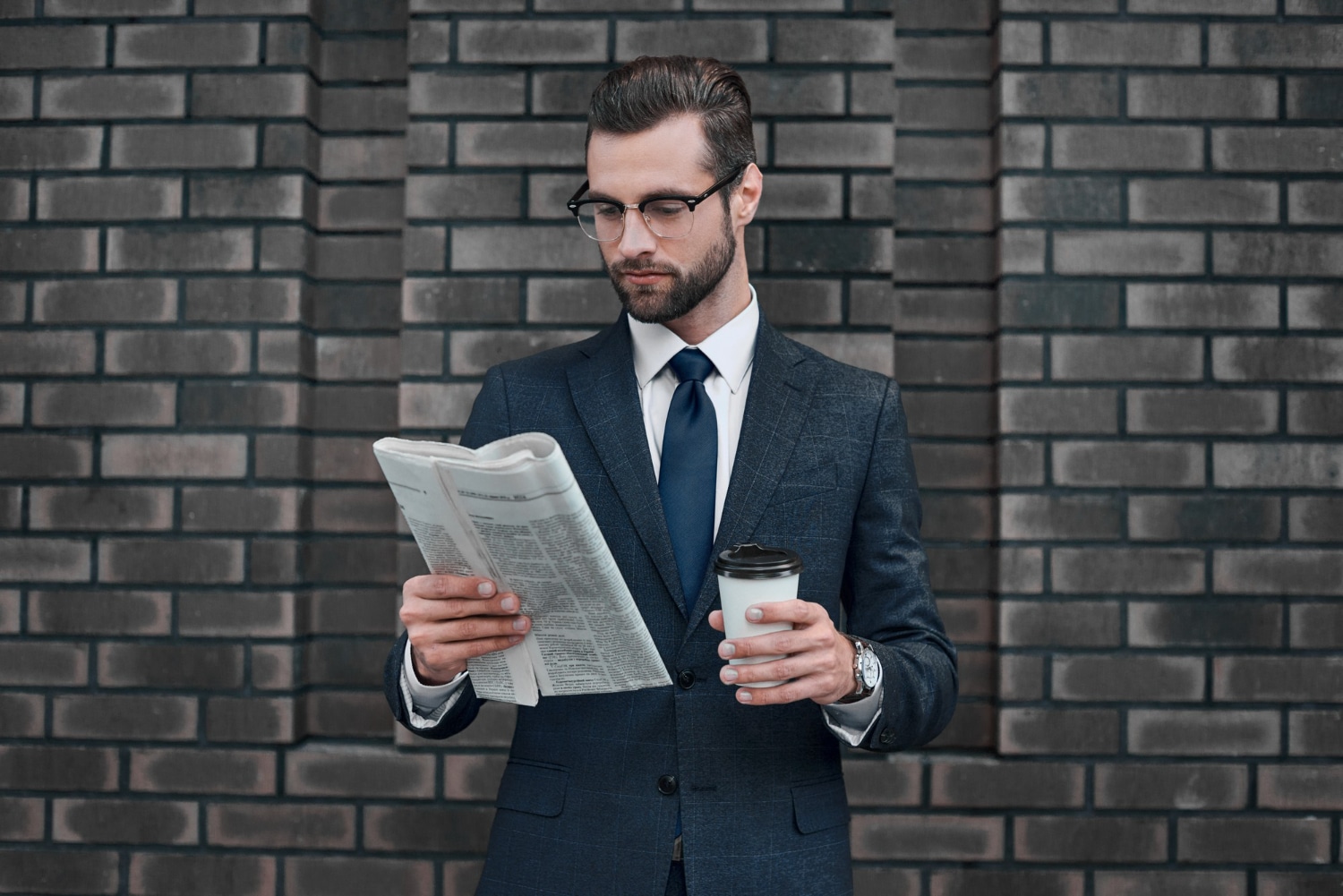 Businessman Reading Newspaper With Coffee On Urban Background